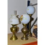 TWO 2OTH CENTURY BRASS BASED OIL LAMPS, A TABLE LAMP IN A SIMILAR STYLE AND TWO TURKISH SYNTHETIC