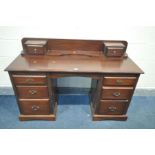 A MAHOGANY DESK, with an arrangement of eight drawers, width 104cm x depth 51cm x height 89cm