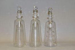 A PAIR OF 20TH CENTURY DECANTERS OF CONICAL FORM AND ANOTHER SIMILAR, the pair etched with