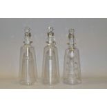 A PAIR OF 20TH CENTURY DECANTERS OF CONICAL FORM AND ANOTHER SIMILAR, the pair etched with