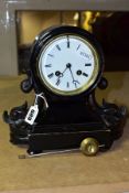 A VICTORIAN EBONISED MANTEL CLOCK, the balloon shaped case flanked to each side by carved