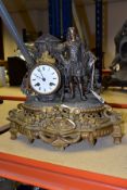 A LATE 19TH CENTURY FRENCH GILT METAL AND BRONZED FIGURAL MANTEL CLOCK, cast as a Cavalier