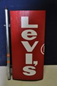 A PAIR OF LEVI'S ADVERTISEMENT SIGNS comprising of a small non electric sign measuring 27cm width