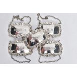 FIVE SILVER DECANTER LABELS, each of a rectangular form with decorative floral and scroll rims,