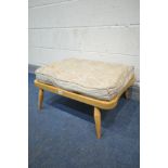 AN ERCOL BLONDE BEECH WINDSOR FOOT STOOL, with a separate cushion (the cushion does not comply