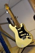 A SQUIER BY FENDER STRATOCASTER in ivory with black scratchplate, Rosewood fingerboard on a maple