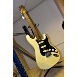 A SQUIER BY FENDER STRATOCASTER in ivory with black scratchplate, Rosewood fingerboard on a maple