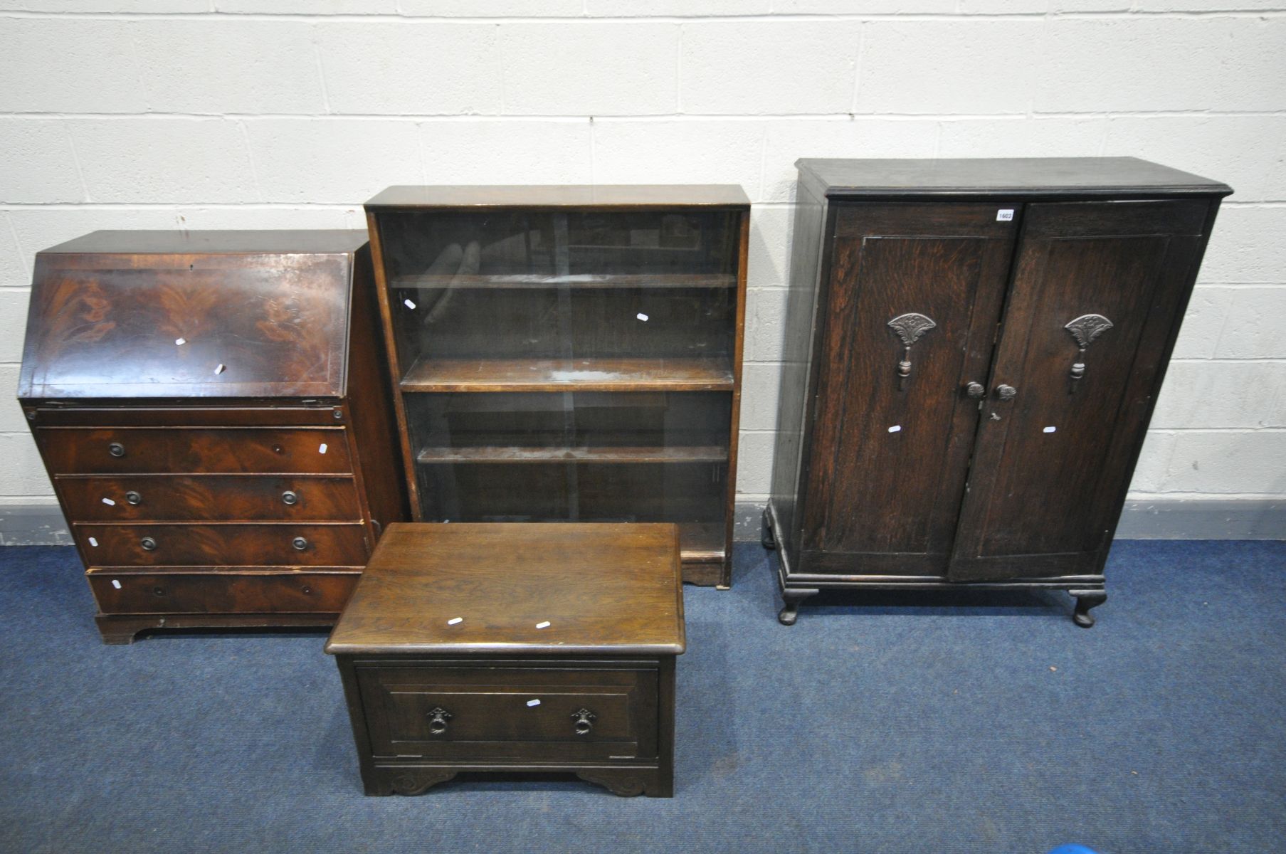 AN OAK PANELLED DOUBLE DOOR CUPBOARD, along with a mahogany bureau, oak bookcase, oak tv stand and