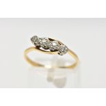 A YELLOW METAL FOUR STONE DIAMOND RING, designed with four illusion set single cut diamonds,