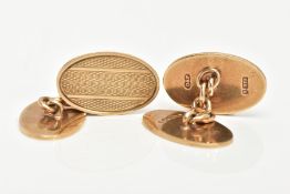 A PAIR OF 9CT GOLD ENGINE TURNED CUFFLINKS, each of an oval form, fitted together with curb links,