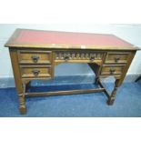 AN OLD CHARM STYLE OAK DESK, with a red leather and gilt tooled inlay top, and five drawers, width