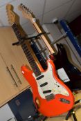 TWO STRAT TYPE ELECTRIC GUITARS one black with a white Pearloid scratchplate no makers name but