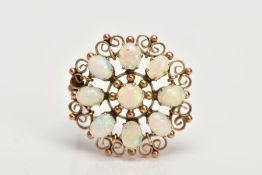 A YELLOW METAL OPAL BROOCH, of a circular form set with eight oval opal cabochons and a central