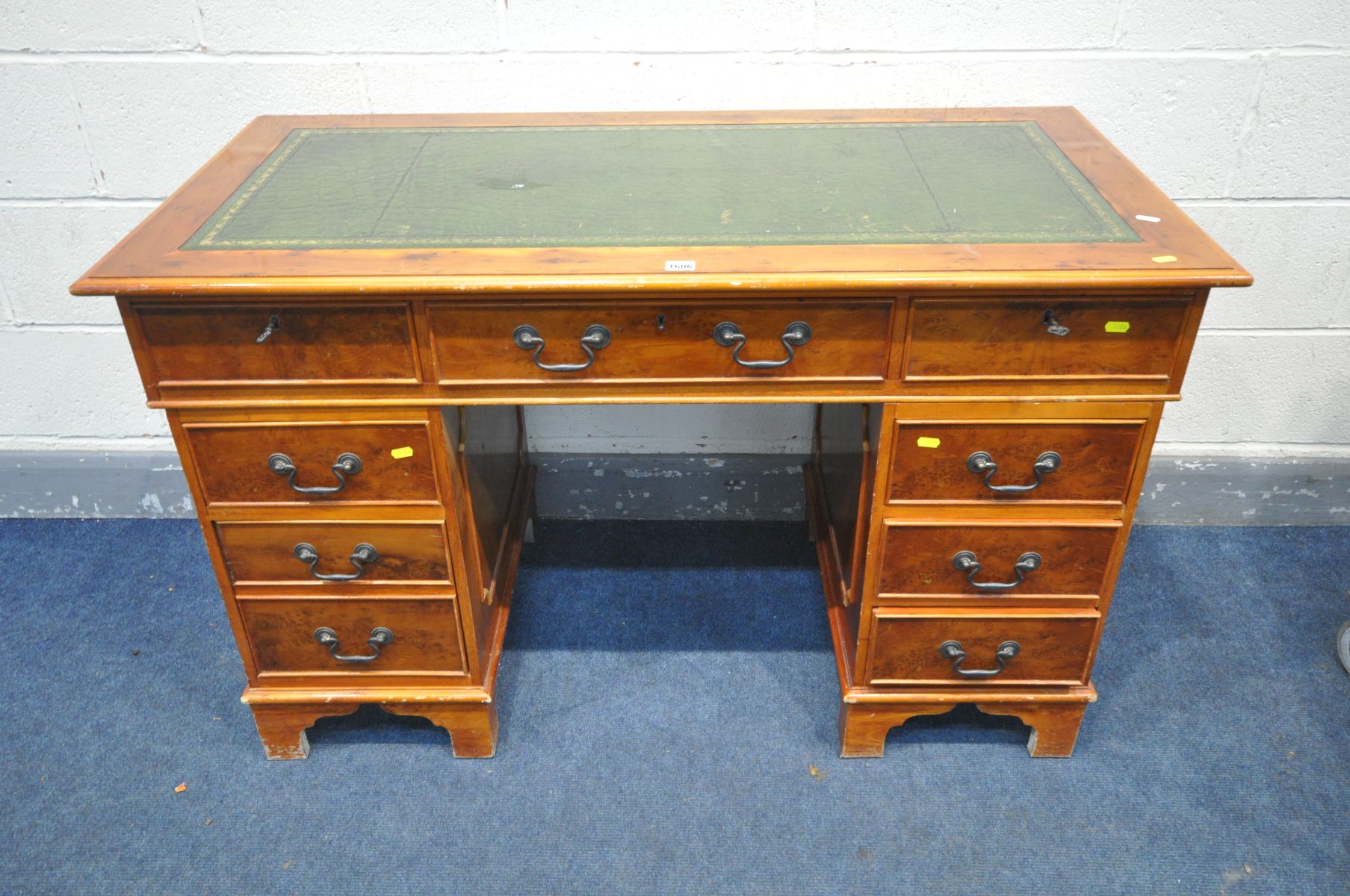 A REPRODUCTION YEW WOOD PEDESTAL DESK, green tooled leather inlay top, width 124cm x depth 62cm x