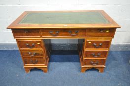 A REPRODUCTION YEW WOOD PEDESTAL DESK, green tooled leather inlay top, width 124cm x depth 62cm x