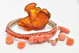 A SELECTION OF CORAL JEWELLERY AND AN AMBER CARVING, to include a white metal hinged bangle set with