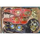 A BOX OF HORSE BRASSES, some on leather straps, including an extra-large brass, with approximately