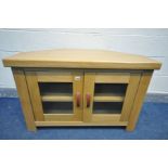 A SOLID OAK CORNER TV STAND with leatherette handles, width 106cm x depth 56cm x height 69cm (