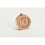 A 9CT GOLD MONEY CHARM, of a circular form inset with a ten shilling banknote, hallmarked 9ct gold