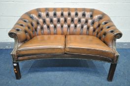 A BUTTONED TAN LEATHER CHESTERFIELD SOFA, length 132cm