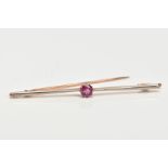 A TOURMALINE BAR BROOCH, a circular cut tourmaline in a nine prong basket setting, affixed to a