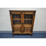 A MELLOWCRAFT OAK LEAD GLAZED DOUBLE DOOR BOOKCASE, with two adjustable shelves, width 97cm x