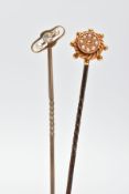 TWO EARLY 20TH CENTURY SEED PEARL STICKPINS, one pin depicting a ships wheel set with eight split