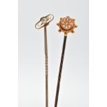 TWO EARLY 20TH CENTURY SEED PEARL STICKPINS, one pin depicting a ships wheel set with eight split