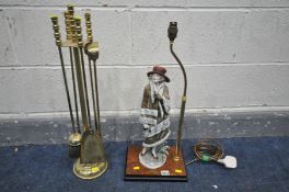 A FOUR PIECE BRASS COMPANION SET, with stand, along with figural table lamp of a standing female,