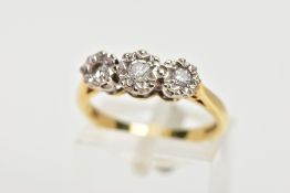 AN 18CT GOLD THREE STONE DIAMOND RING, the three graduated diamonds in illusion settings, leading on