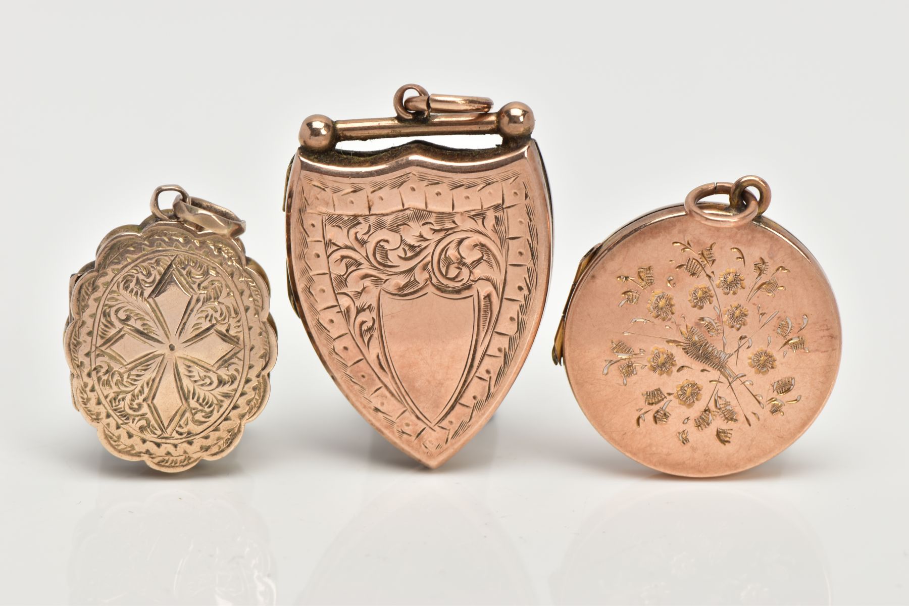 THREE EARLY 20TH CENTURY 9CT FRONT AND BACK LOCKETS, to include a shield shaped locket with embossed