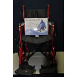 A CARE Co WHEELCHAIR a manual/self-propelled folding wheelchair with footrests and seatbelt along