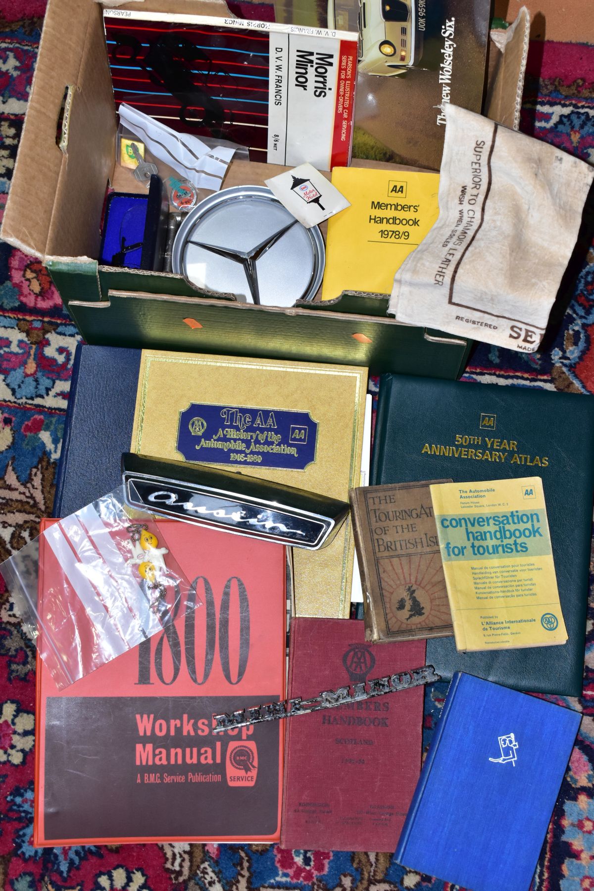 A BOX OF MOTORING ITEMS, to include an Austin 1800 workshop manual, Wolseley Six brochure, car