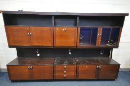 A ULFERTS ROSEWOOD EFFECT THREE SECTION WALL UNIT, comprising of glazed and wooden cupboard doors,