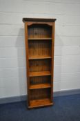 A MODERN PINE NARROW BOOKCASE with two fixed and a two adjustable shelves width 60cm x depth 129cm x