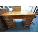 A YEWWOOD PEDESTAL DESK, with brown leather and gilt tooled inlay top, and eight drawers, width
