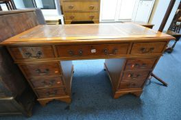 A YEWWOOD PEDESTAL DESK, with brown leather and gilt tooled inlay top, and eight drawers, width