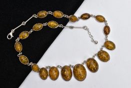 AN IMITATION AMBER NECKLACE, designed as graduated oval cabochons of imitation amber, each in