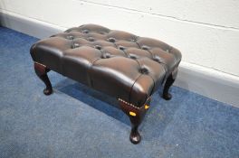 A BROWN LEATHER BUTTONED FOOTSTOOL, on cabriole, length 83cm x depth 39cm x height 33cm