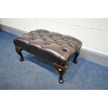 A BROWN LEATHER BUTTONED FOOTSTOOL, on cabriole, length 83cm x depth 39cm x height 33cm