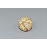 A VICTORIAN HAND STITCHED WHITE LEATHER GOLF BALL, an area of leather is missing and exposes thread,