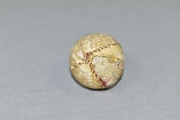 A VICTORIAN HAND STITCHED WHITE LEATHER GOLF BALL, an area of leather is missing and exposes thread,