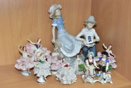 A GROUP OF CERAMIC FIGURINES, to include a Nao by Lladro Tender Moment figurine of a boy bandaging a