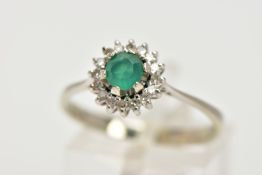 A GREEN CHALCEDONY AND DIAMOND CLUSTER RING, the central circular green chalcedony within a single