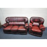 A RED LEATHER TWO PIECE LOUNGE SUITE comprising a three seat settee, width 184cm and an armchair,