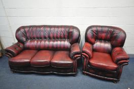 A RED LEATHER TWO PIECE LOUNGE SUITE comprising a three seat settee, width 184cm and an armchair,