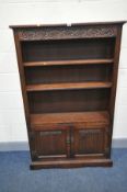 AN OLD CHARM BOOKCASE with two linen fold cupboard doors below two adjustable shelves width 96cm x