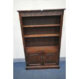 AN OLD CHARM BOOKCASE with two linen fold cupboard doors below two adjustable shelves width 96cm x