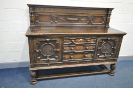 AN EARLY 20th CENTURY HEAVILY CARVED OAK SIDEBOARD with raised back, geometric detailing, two