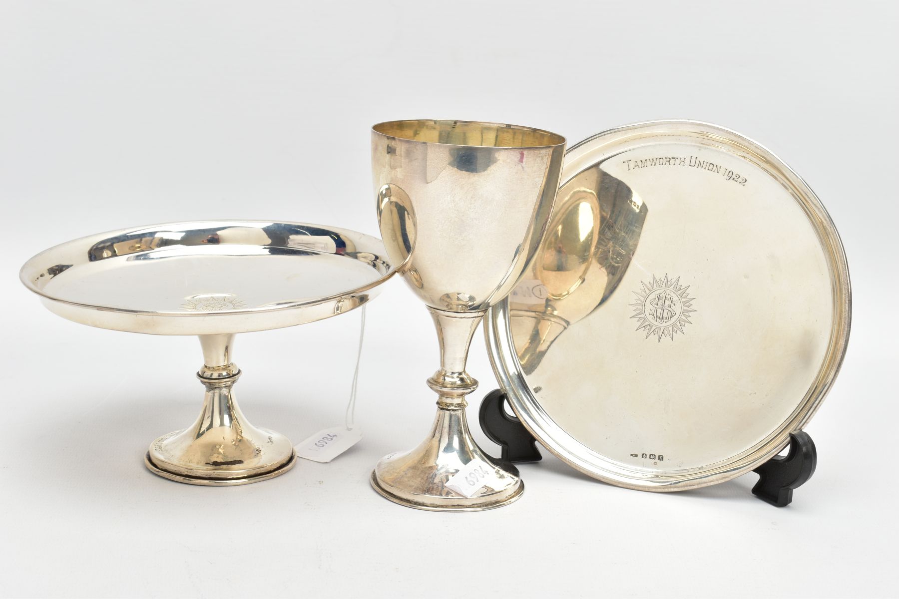 THREE SILVER ITEMS, to include a goblet of a plain polished design with an engraved motif, slight